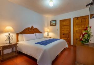 Postel nebo postele na pokoji v ubytování Hotel la Parroquia