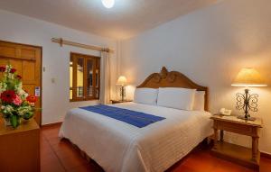 Postel nebo postele na pokoji v ubytování Hotel la Parroquia