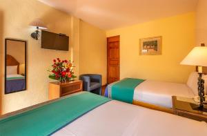 Postel nebo postele na pokoji v ubytování Hotel la Parroquia