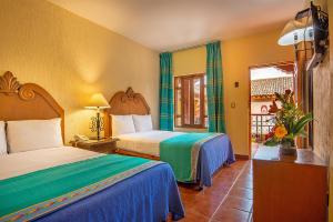 Postel nebo postele na pokoji v ubytování Hotel la Parroquia