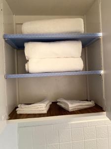 a closet with towels and towels on shelves at Spacious 3bedroom free wine,WiFi,and parking in Milwaukee