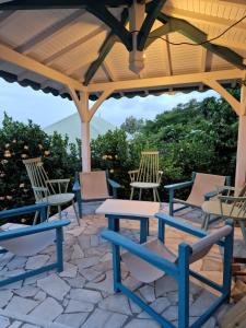 a picnic table and chairs under a wooden pavilion at Ocean View Villa in Le François