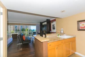 a kitchen with a counter and a living room at Ilikai Tower 420 Lagoon View 1BR in Honolulu