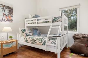 a white bunk bed in a room with a couch at Rural 5 Star Villa's with Resort Amenities in Cowes