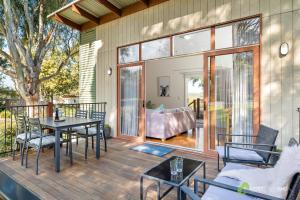 a patio with a table and chairs on a deck at Rural 5 Star Villa's with Resort Amenities in Cowes