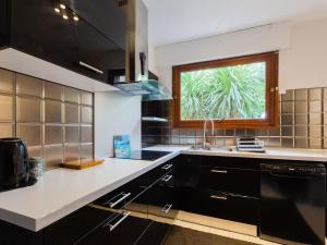 a kitchen with a sink and a window at Elegant holiday home with pool in Toulon