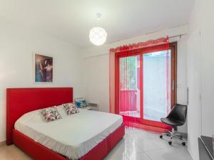 a bedroom with a red bed and a window at Elegant holiday home with pool in Toulon