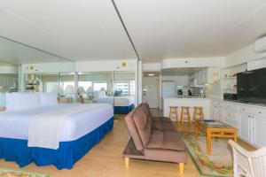 ein großes Schlafzimmer mit einem großen Bett und einer Küche in der Unterkunft Ilikai Tower 839 Yacht Harbor View 1BR in Honolulu