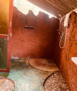 a dirty bathroom with a shower and a sink at Sanctuary Lanta in Ko Lanta
