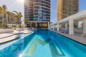 a swimming pool with two tall buildings at Meriton Suites Surfers Paradise in Gold Coast