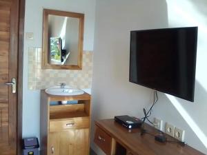 a flat screen tv hanging on a wall at Puri Raka Villa in Pabean Buleleng