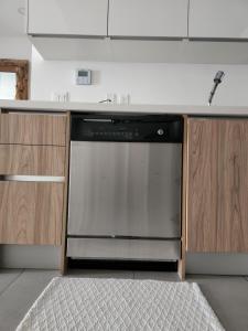 a dishwasher in a kitchen with a counter top at ARUBA DREAM GETAWAY 2BR/2BT OCEAN & POOL VIEW in Oranjestad