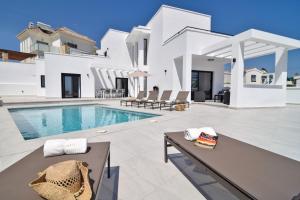 a villa with a swimming pool and a house at Villa Rosamar by Villa Plus in Frigiliana