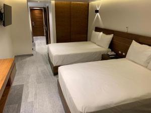 Postel nebo postele na pokoji v ubytování Hotel Plaza Kokai Cancún