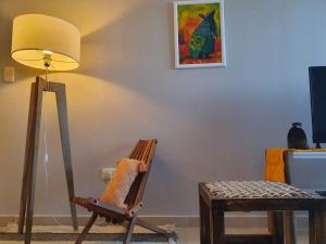 a living room with a chair and a lamp at Marfil in Posadas