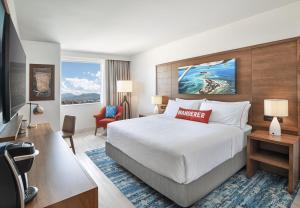 a hotel room with a bed and a desk at Compass by Margaritaville Medford in Medford