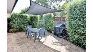 a patio with a table and chairs and a net at Family Retreat on Anderson in Inverloch