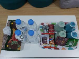 a tray filled with water bottles and other snacks at Chin-Lan B&B in Zhuangwei