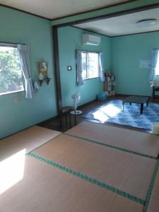 sala de estar con paredes azules y alfombra en Minami Onna Tropical en Onna