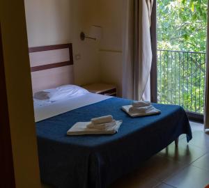 Postel nebo postele na pokoji v ubytování Hotel Milomax
