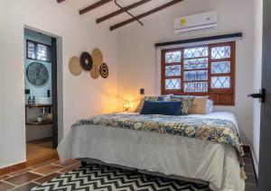 a bedroom with a bed and a window at Casa Medallo in Medellín