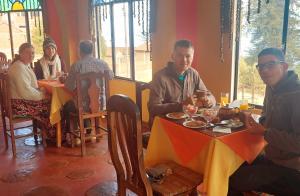 a group of people sitting at a table in a restaurant at Suma Uta in Copacabana