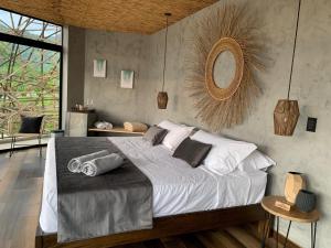 a bedroom with a large bed and a large window at IslaVerde Hotel in La Mesa