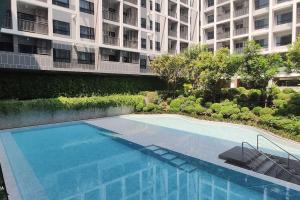 a swimming pool in front of a building at Dusit D2 Huahin - In the heart of Hua Hin, Walk to the beach in 6 minutes 400m, Free WiFi in Hua Hin
