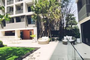 a courtyard with two chairs and a building at Dusit D2 Huahin - In the heart of Hua Hin, Walk to the beach in 6 minutes 400m, Free WiFi in Hua Hin