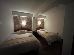 سرير أو أسرّة في غرفة في Hotel Choquequirao