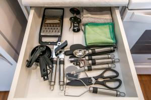 a drawer filled with various items in a box at Steamy Romantic Greek Corneer Suite King U/G Wifi in Edmonton