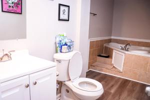 a bathroom with a toilet and a sink and a tub at Luxury 2BR 1bt Suite basement Vacation House Private Entrance in Lithonia