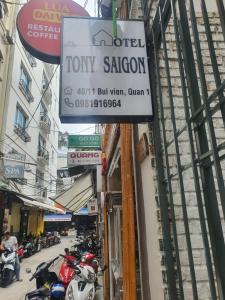 a sign for a hotel tommy saigon on a street at Tony SaiGon Hotel in Ho Chi Minh City