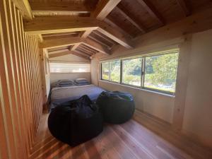 ein Schlafzimmer mit einem Bett in einem winzigen Haus in der Unterkunft CrossFit Otoyo Strength TINY HOUSE in Otoyocho