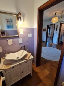 a bathroom with a sink and a mirror and a hallway at Auszeit an der Nordsee in Husum