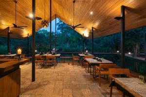 a restaurant with tables and chairs on a patio at Taru Villas Maia - Habarana in Habarana