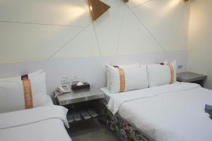 Postel nebo postele na pokoji v ubytování 柜富賓王旅店-台北館 Giant Rich King Plaza Hotel