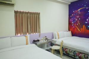 Postel nebo postele na pokoji v ubytování 柜富賓王旅店-台北館 Giant Rich King Plaza Hotel