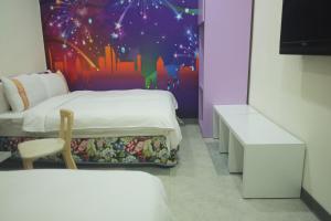 Postel nebo postele na pokoji v ubytování 柜富賓王旅店-台北館 Giant Rich King Plaza Hotel