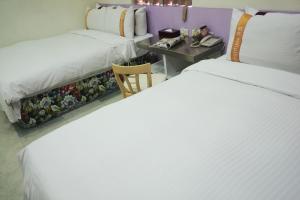 Postel nebo postele na pokoji v ubytování 柜富賓王旅店-台北館 Giant Rich King Plaza Hotel