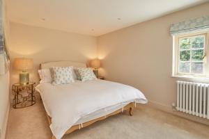 a bedroom with a white bed and a window at 21 Pound Street in Petworth