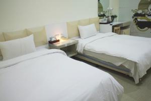 Postel nebo postele na pokoji v ubytování 柜富賓王旅店-台北館 Giant Rich King Plaza Hotel