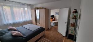 a small bedroom with a bed and a window at FeWo-Kerstin, Malchin in Malchin