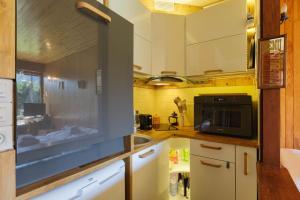 a kitchen with a sink and a microwave at Résidence Grands Montets 221 ski in-ski out - Happy Rentals in Chamonix