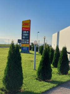 a gas station sign in a field with bushes at Cazare Pensiunea Ewo in Moraviţa +4 photos