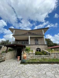 a large brick building with a balcony on top at Country House in Mercogliano