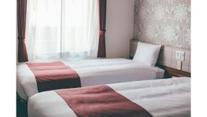 Postel nebo postele na pokoji v ubytování Kuretake Inn Premium Shizuoka Annex