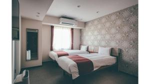 Ένα ή περισσότερα κρεβάτια σε δωμάτιο στο Kuretake Inn Premium Shizuoka Annex