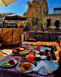 a table with plates of food on a table at Kaya Konak Cave in Nevsehir