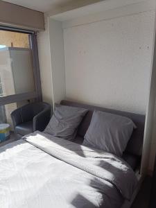 a bed with white sheets and pillows in a room at auris en oisans, vue sur le massif des ecrins in Auris